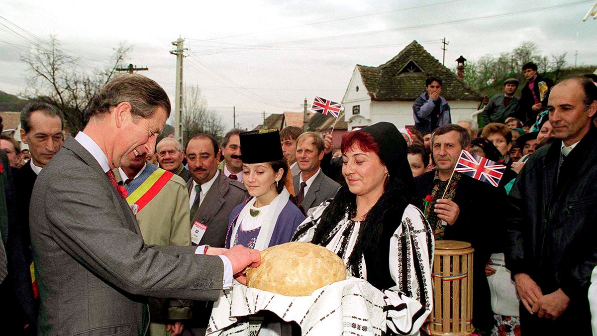 A young King Charles admiring a loaf of bread.