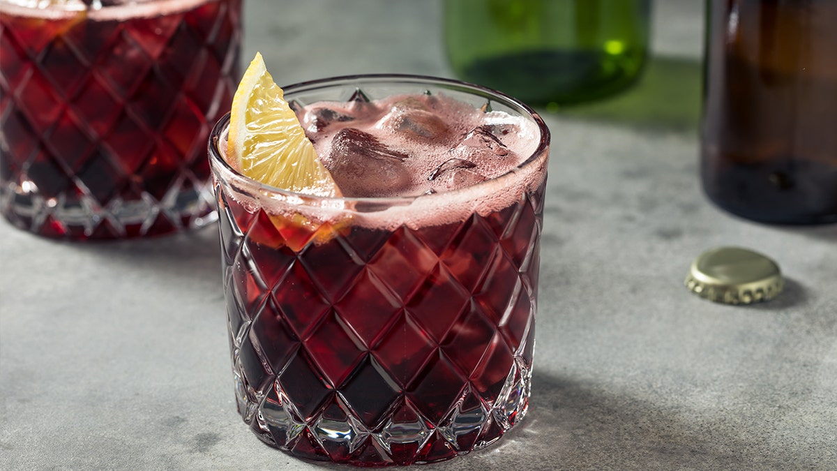 Close-up of kalimotxo with lemon sticking out