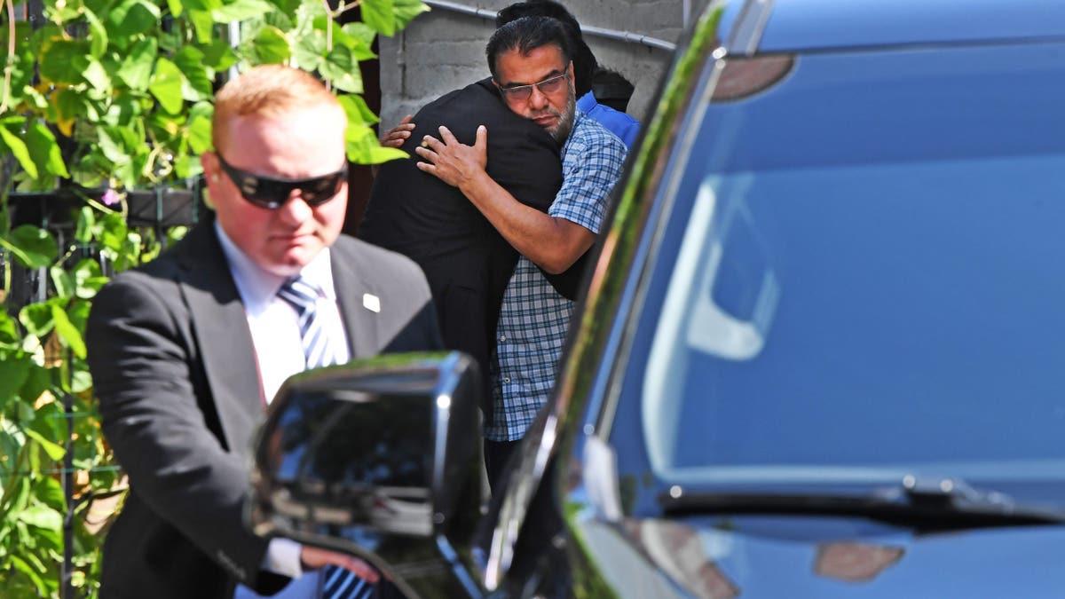 Mamdani hugs man outside Islam family home