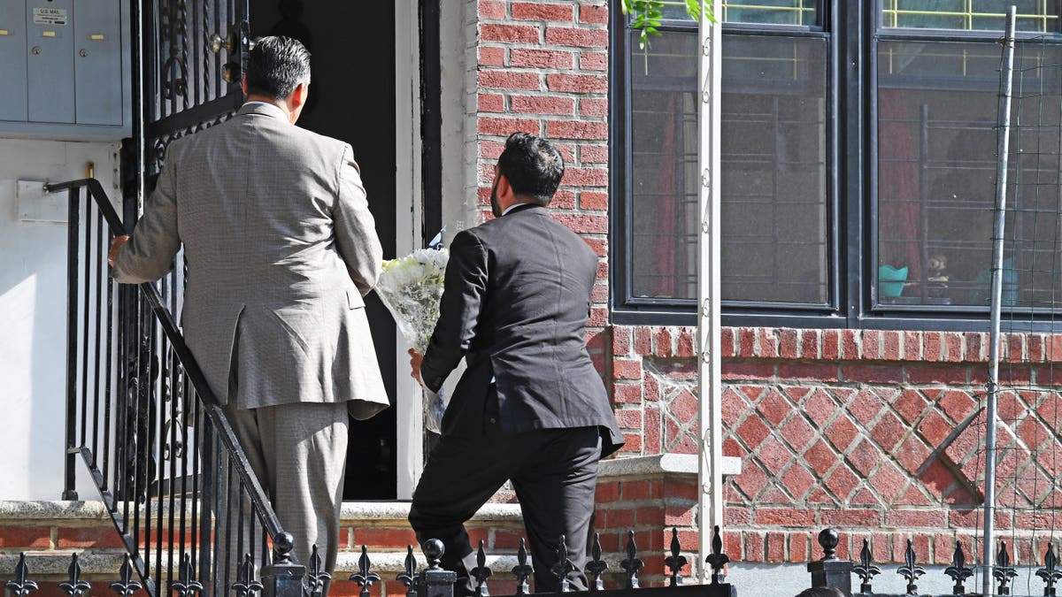 Mamdani on stoop of Islam family home