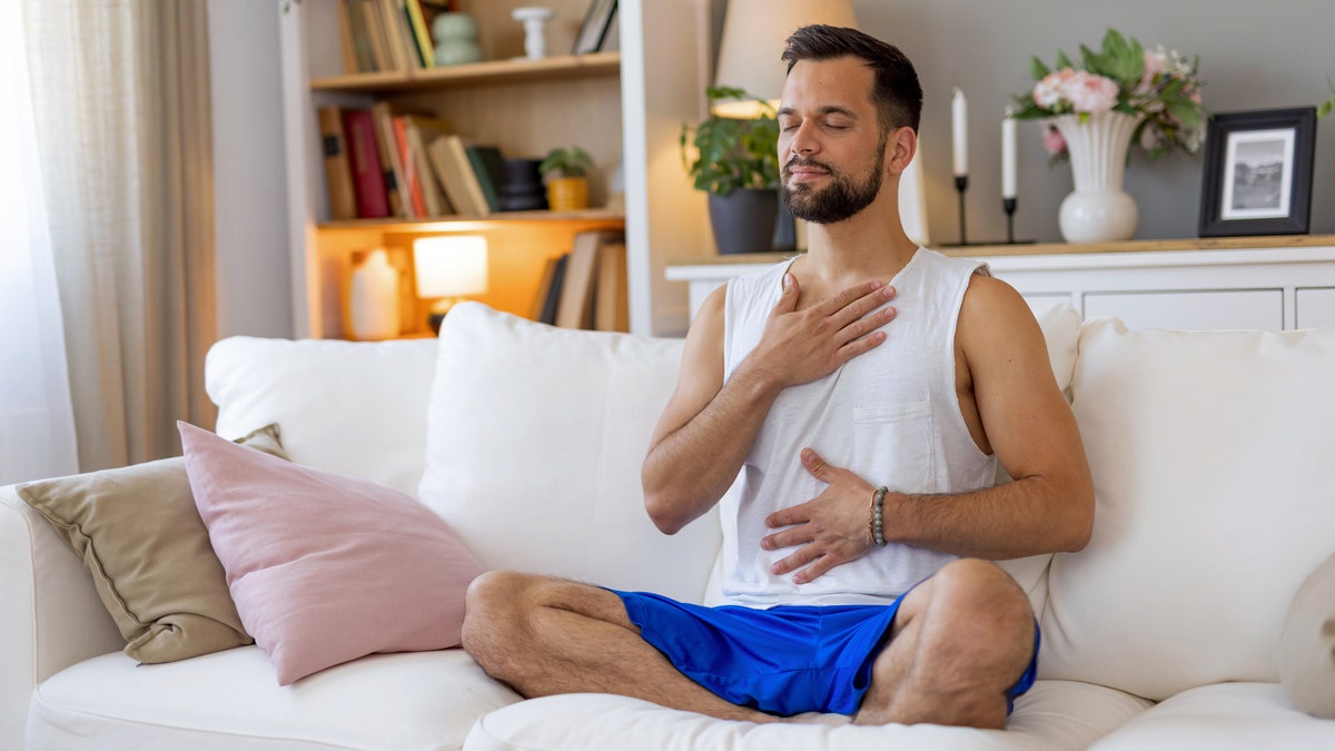 Man holding stomach and chest