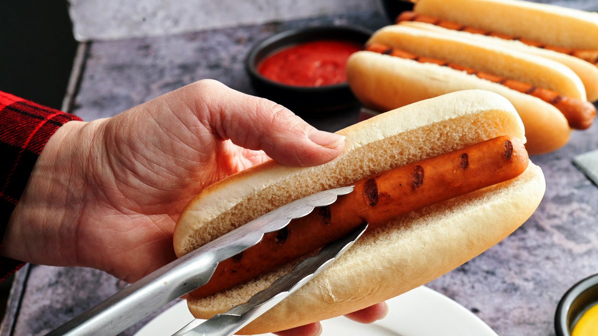 Man preparing hot dog