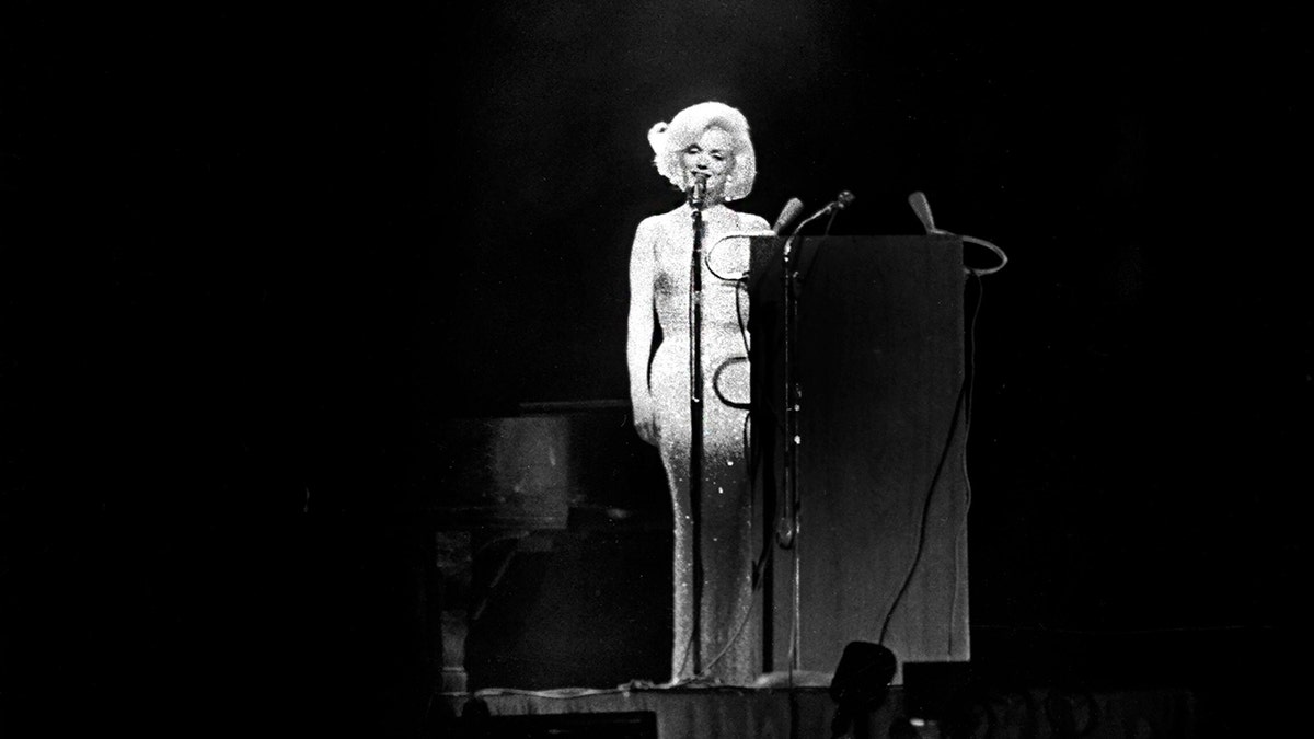 Marilyn Monroe on stage singing.