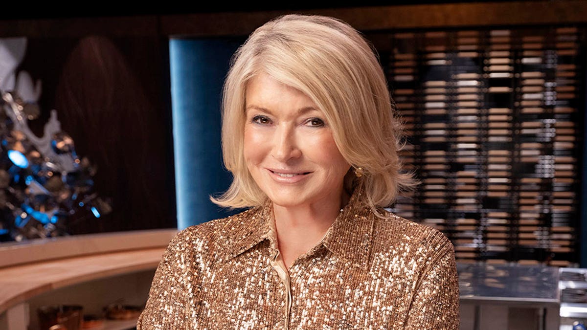 martha stewart wearing a gold sequined shirt and crossing her arms while smiling