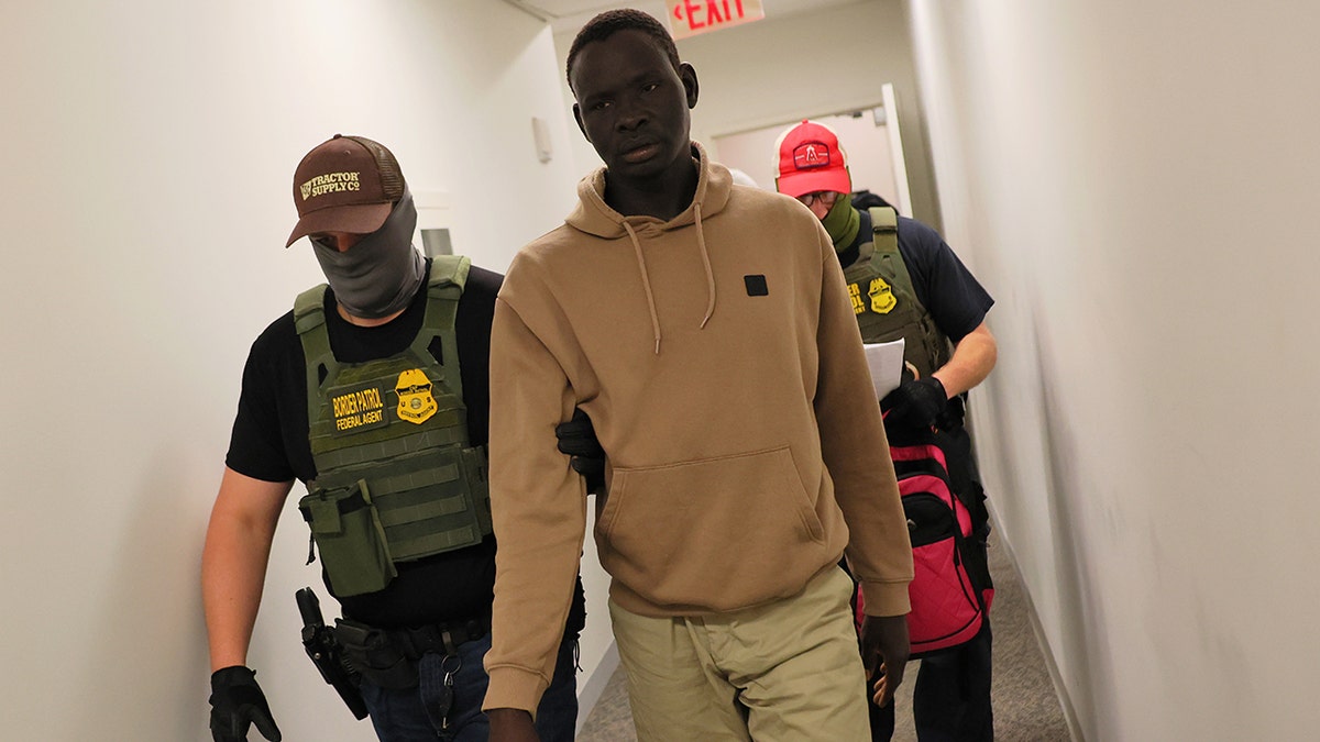 Federal agents detain a man after his court hearing in immigration court at the Ted Weiss Federal Building on July 09, 2025 in New York City.