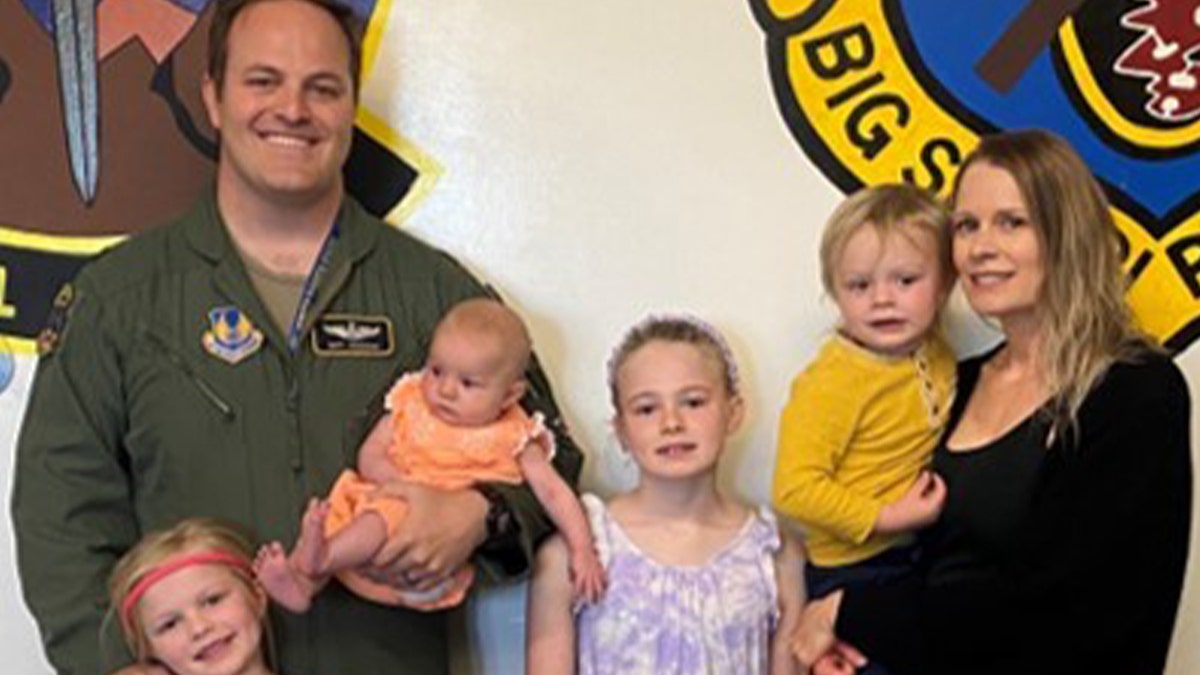 USAF Lt. Col. Matt Anderson with his wife and his children.