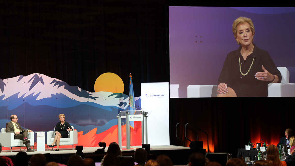 McMahon on big screen, right, and on stage