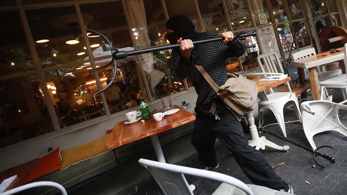 Locals tell Americans to 'respect my culture' during Mexico City protests 3 MEXICO CITY, MEXICO - JULY 04: Demonstrator throws objects at a restaurant during the first anti-gentrification protest, in Mexico City, Mexico on July 04, 2025. People gathered to take part in the first anti-gentrification demonstration to protest against its social and economic negative impact as displacement of residents, an increase of cost of living and accommodation costs for locals caused by the influx of foreign people living in the country. (Photo by Daniel Cardenas/Anadolu via Getty Images)