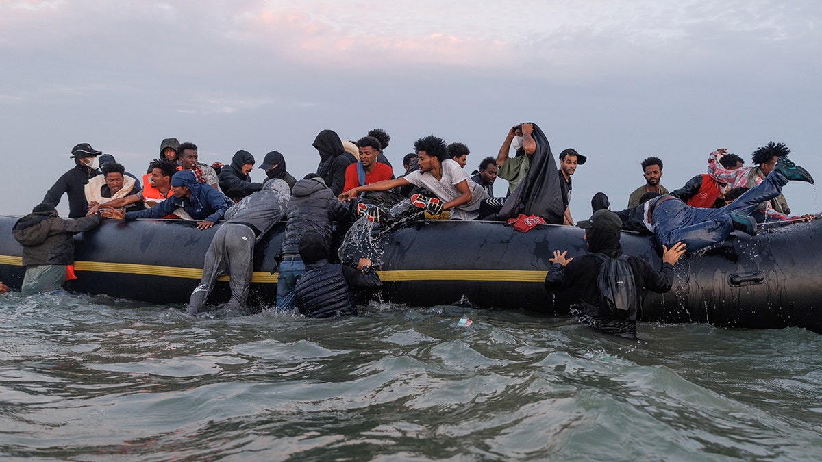 Migrants enter the waters off Gravelines, France, with smugglers in charge of the scene