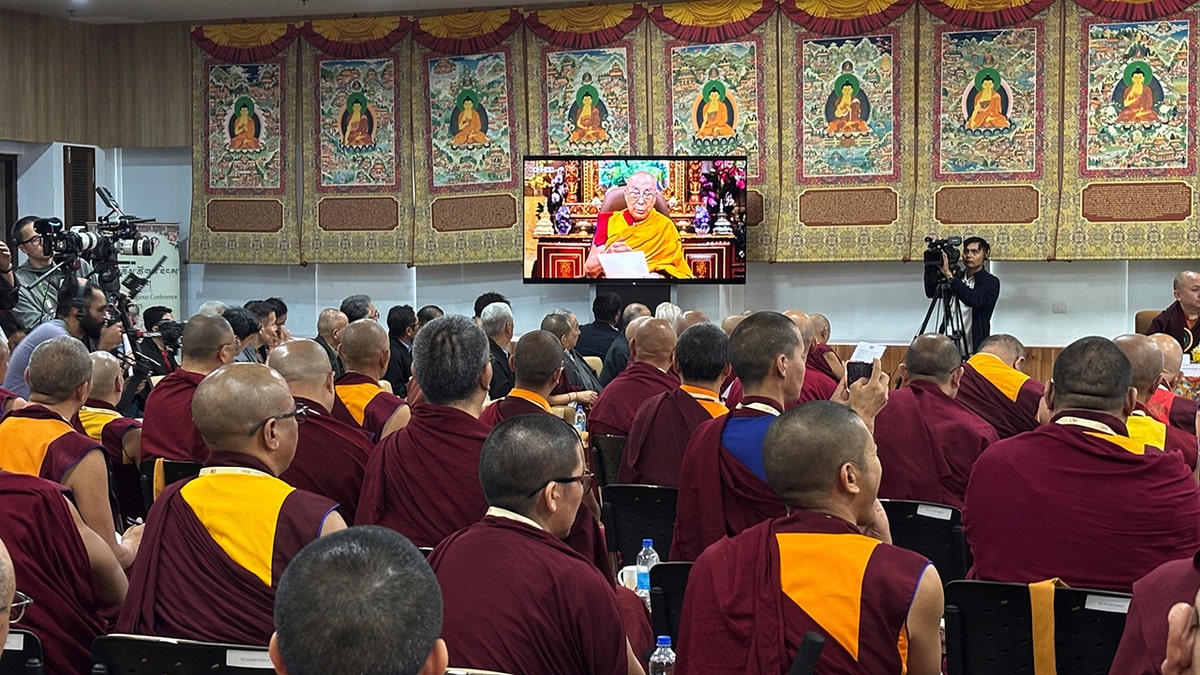 Monks listen to the Dalai Lama