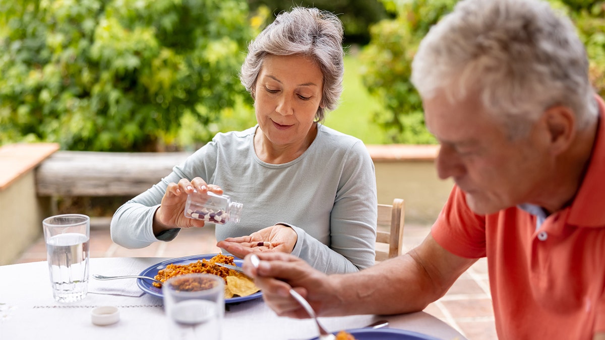 Older people eating multivitamins at breakfast