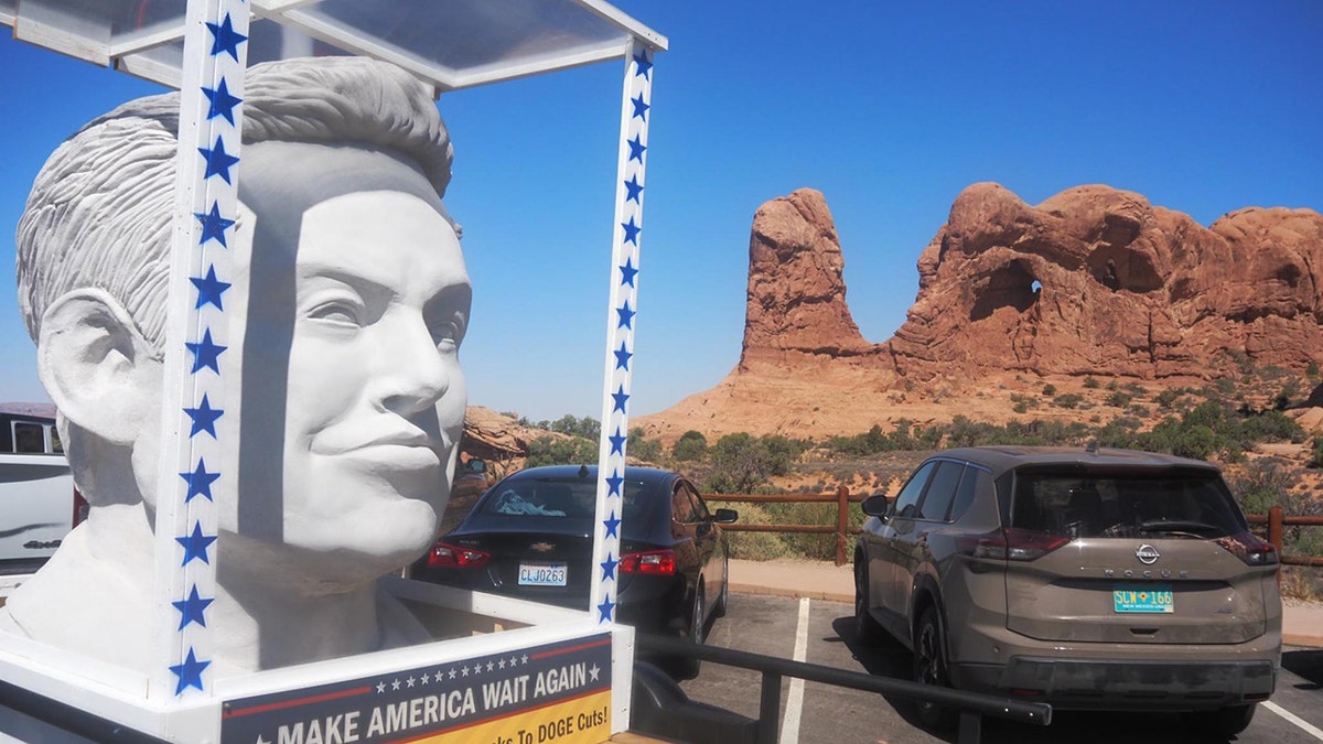 Elon Musk statue in front of Arches National Park rock formations