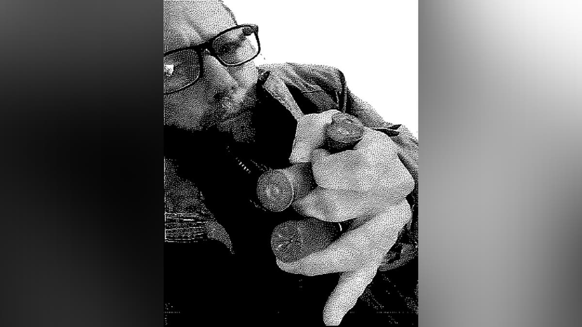 Michael Gann holding explosive devices
