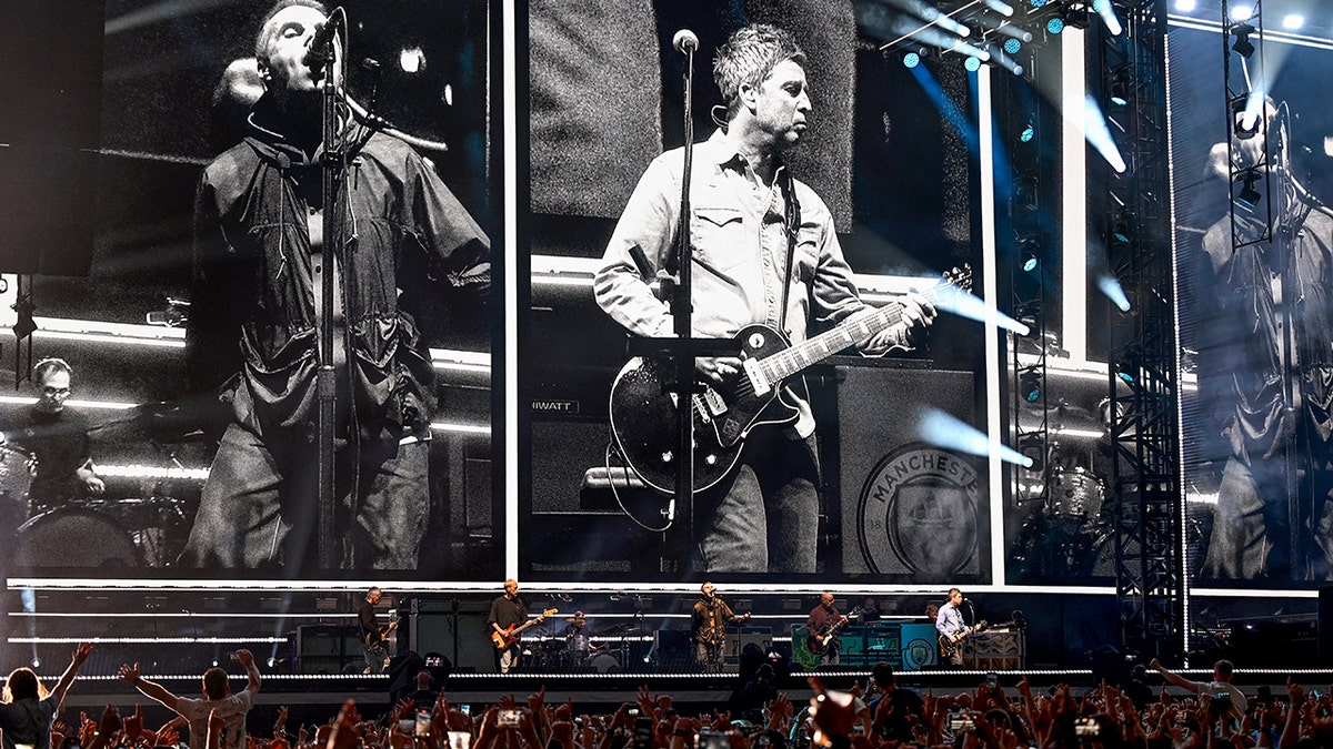 Oasis performs on stage in Wales