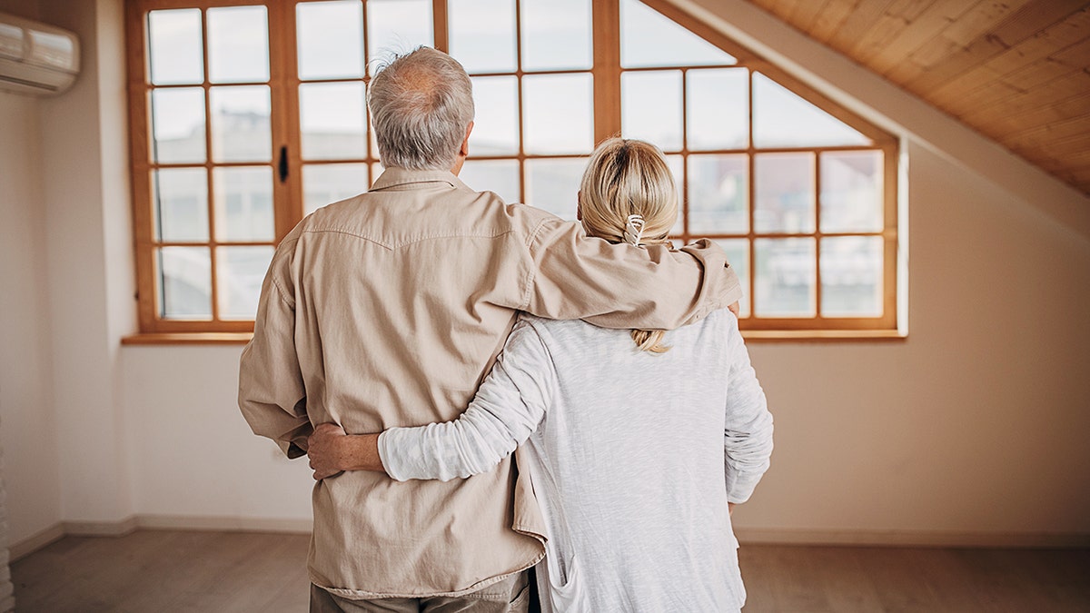Older couple hugging.
