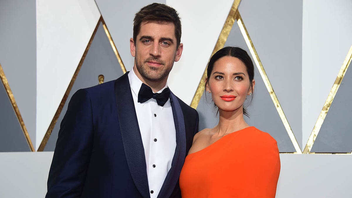 olivia munn poses with aaron rodgers on the red carpet in 2016