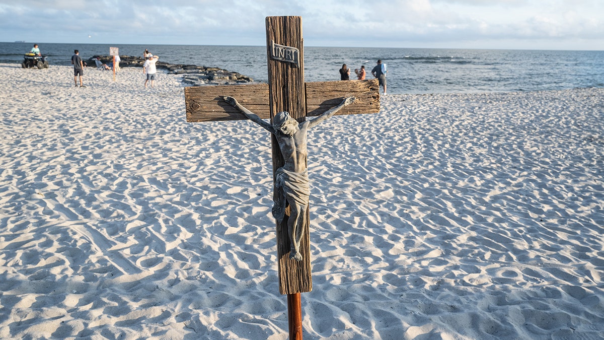 A crucifix on the sand at a beach