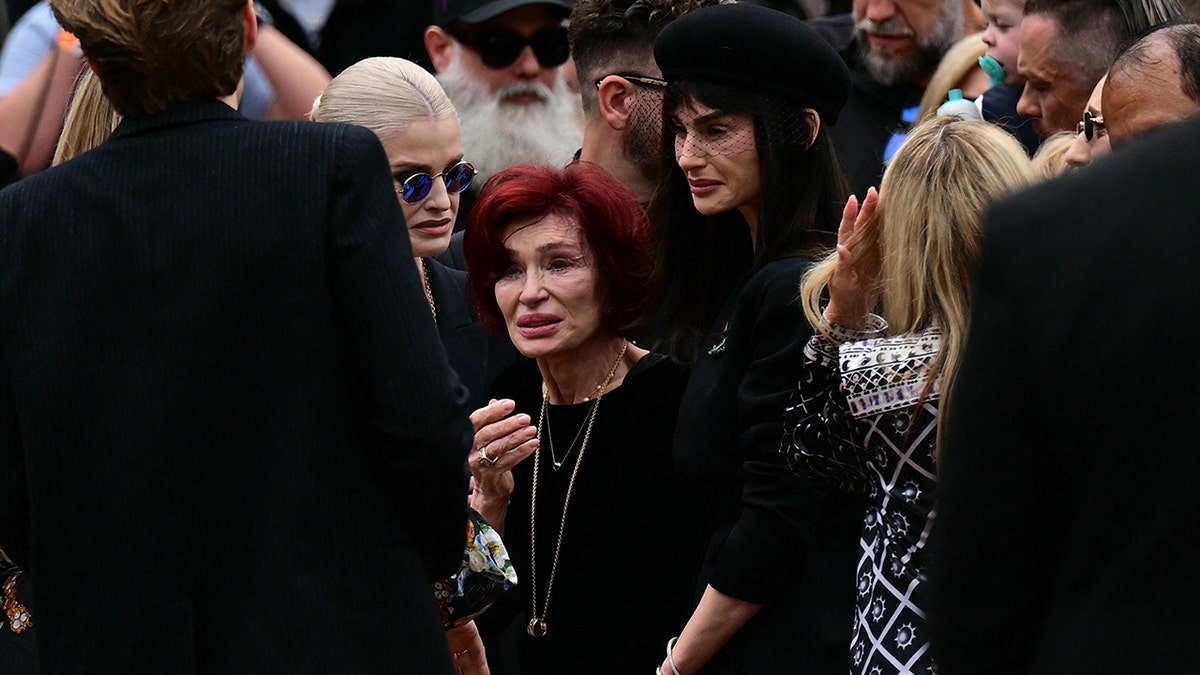 Sharon Osbourne stands with Kelly and Aimee Osbourne at Ozzy Osbourne's funeral procession