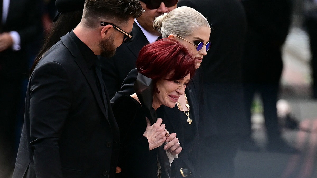 Sharon Osbourne and children crying at Ozzy Osbourne's funeral.