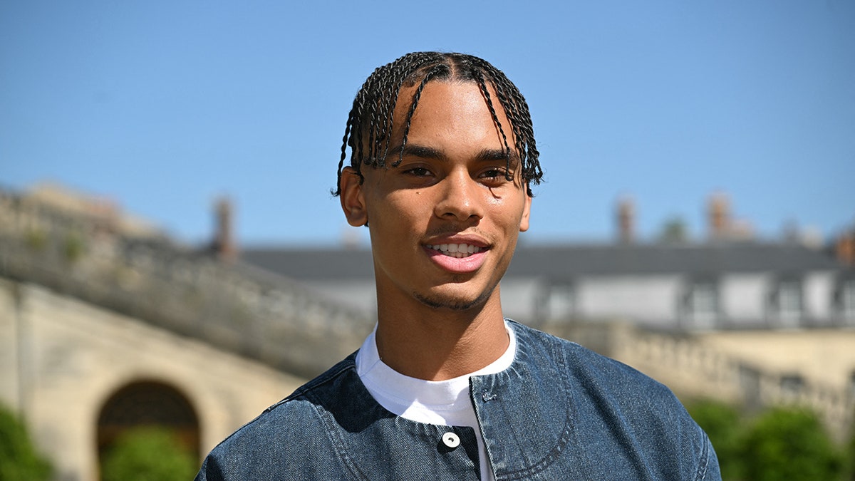 A close-up of Alexandre Grimaldi wearing a denim jacket and a white shirt.
