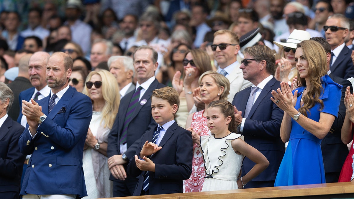 The Wales family applauding at Wimbledon.