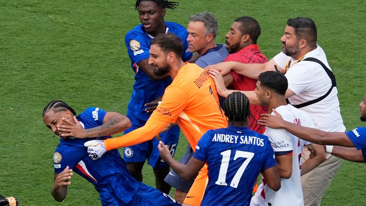 Paris Saint-Germain's goalkeeper Gianluigi Donnarumma pushes a Chelsea player