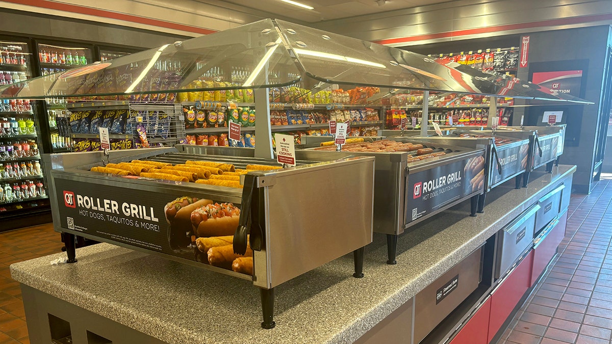 A QuickTrip gas station roller grill is shown.