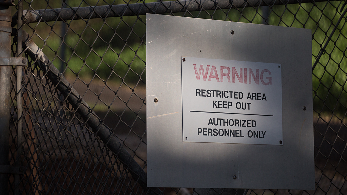 A warning sign posted at one of the entrance gates to Red Hill in Honolulu, HI on December 11, 2021.