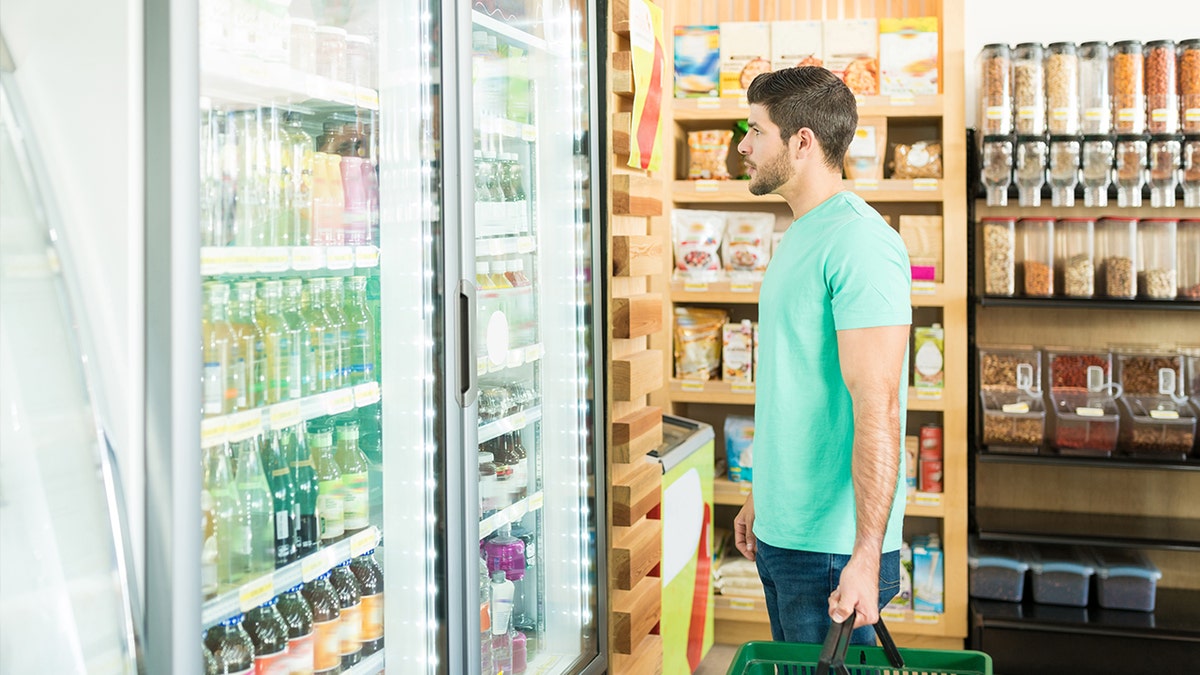 Man looking at the aisle of a drink