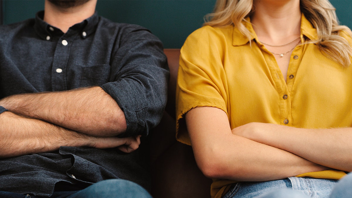 Angry couple crossing arms
