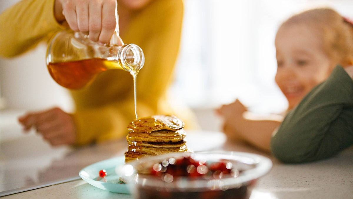 Shed the syrup over women's pancakes