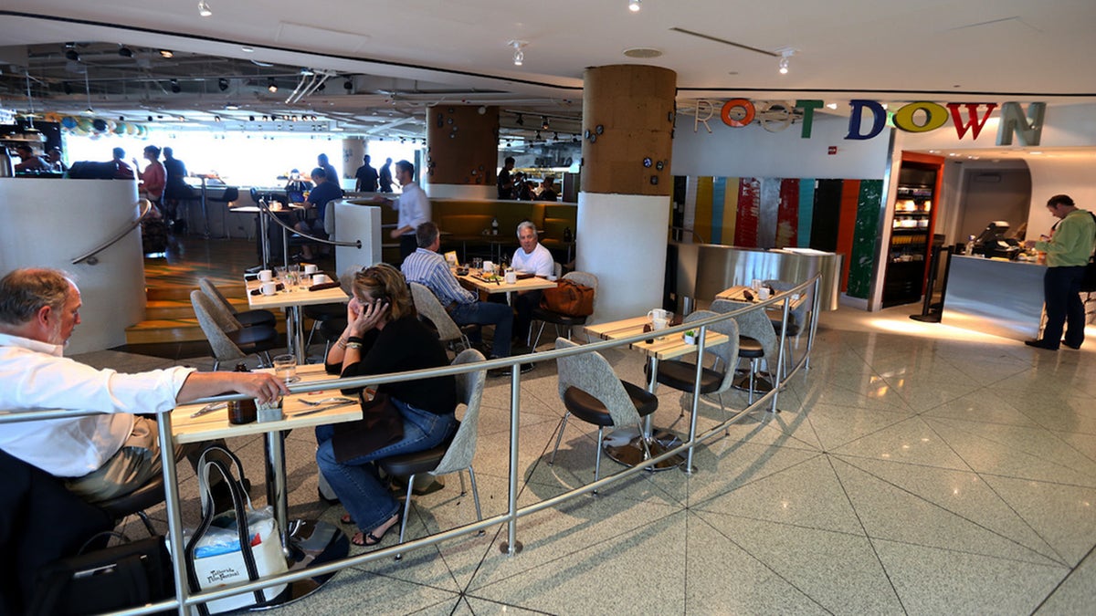 Passengers seen sitting around Root Down restaurant at Denver International Airport.