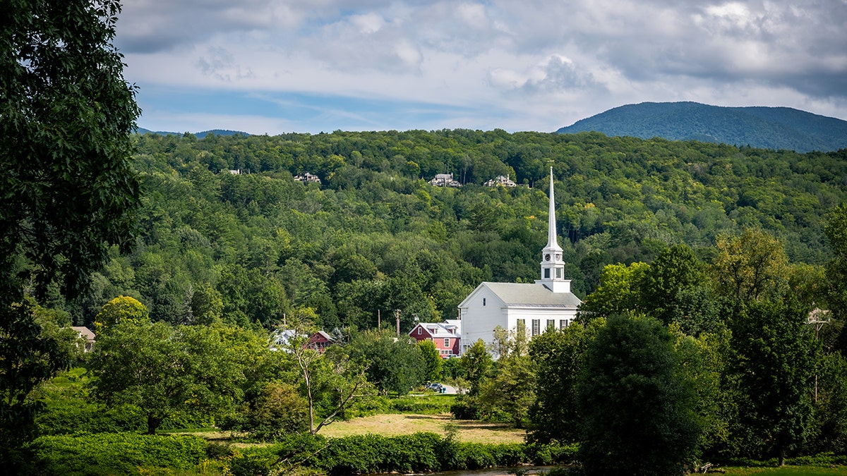 summer view church in rolling vermont hills