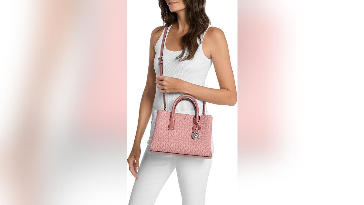 This adorable bag is wrapped in Michael Kors iconic logo.
