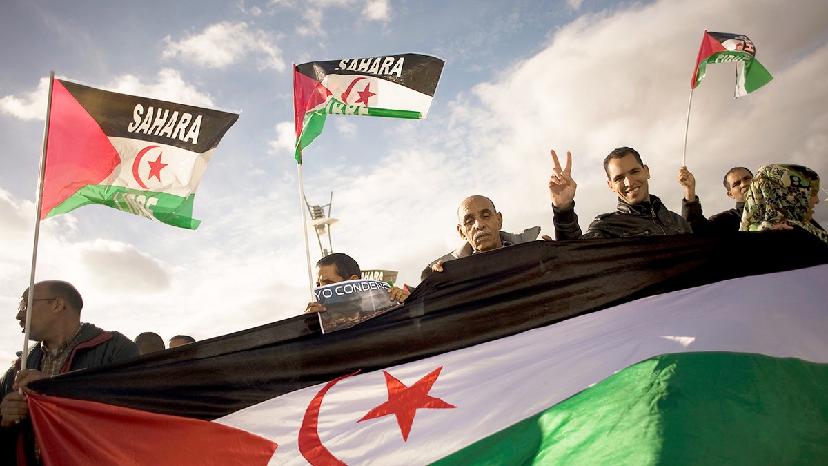 Activists supporting the journalist race keep the Western Sahara flags while protesting the Moroccan occupation