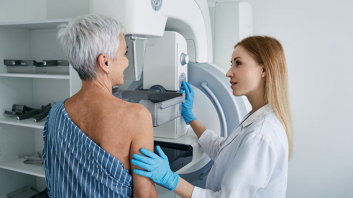 Senior woman having mammography scan at hospital with medical technician. Mammography procedure