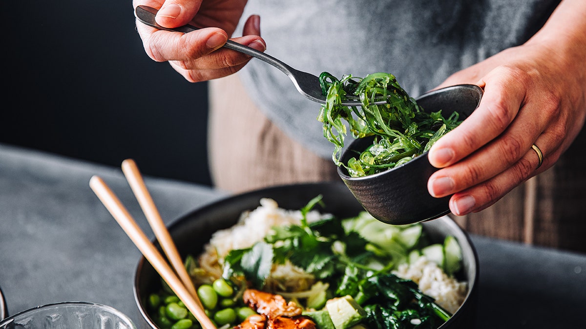 person making healthy green salad