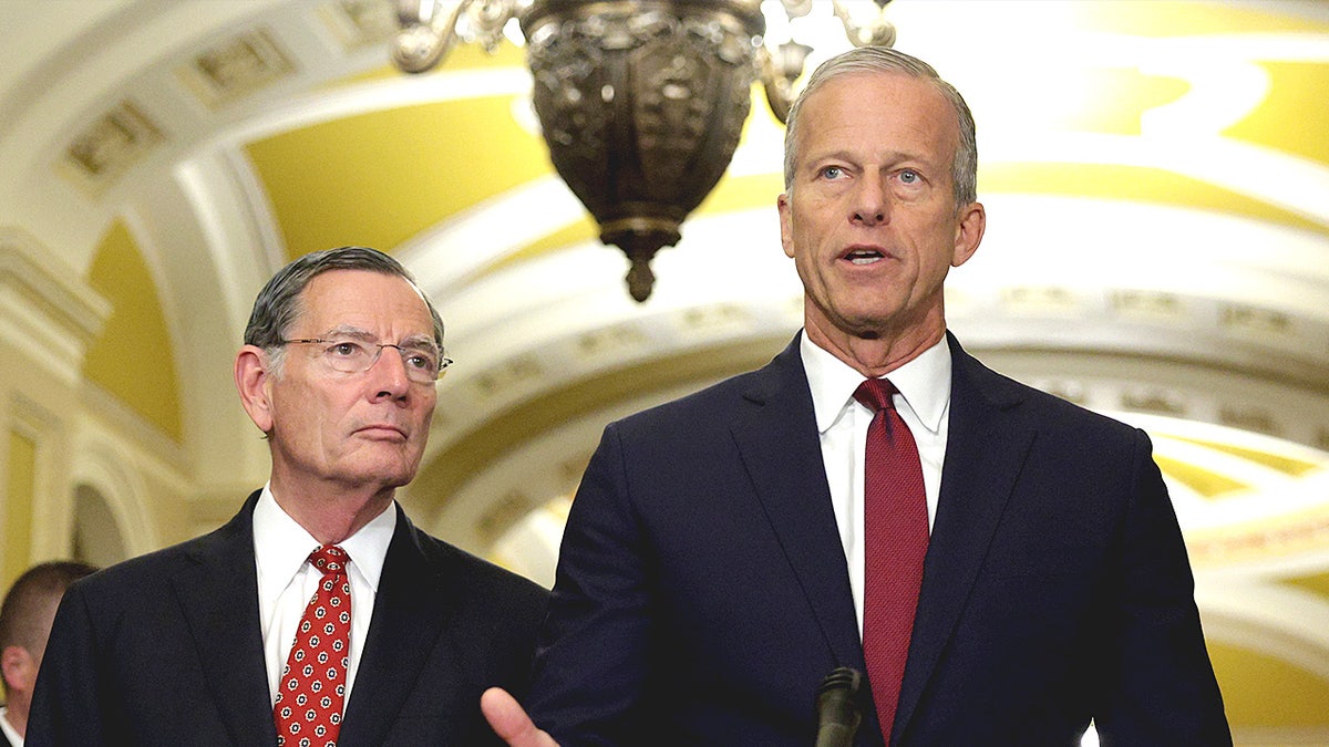 WASHINGTON, DC - JULY 22: U.S. Senate Majority Leader Sen. John Thune (R-SD) (R) speaks as Senate Majority Whip Sen. John Barrasso (R-WY) (L) listens during a news briefing after the weekly Senate Republican policy luncheon at the U.S. Capitol on July 22, 2025 in Washington, DC. Senate GOPs held a weekly policy luncheon to discuss the Republican agenda. (Photo by Alex Wong/Getty Images)