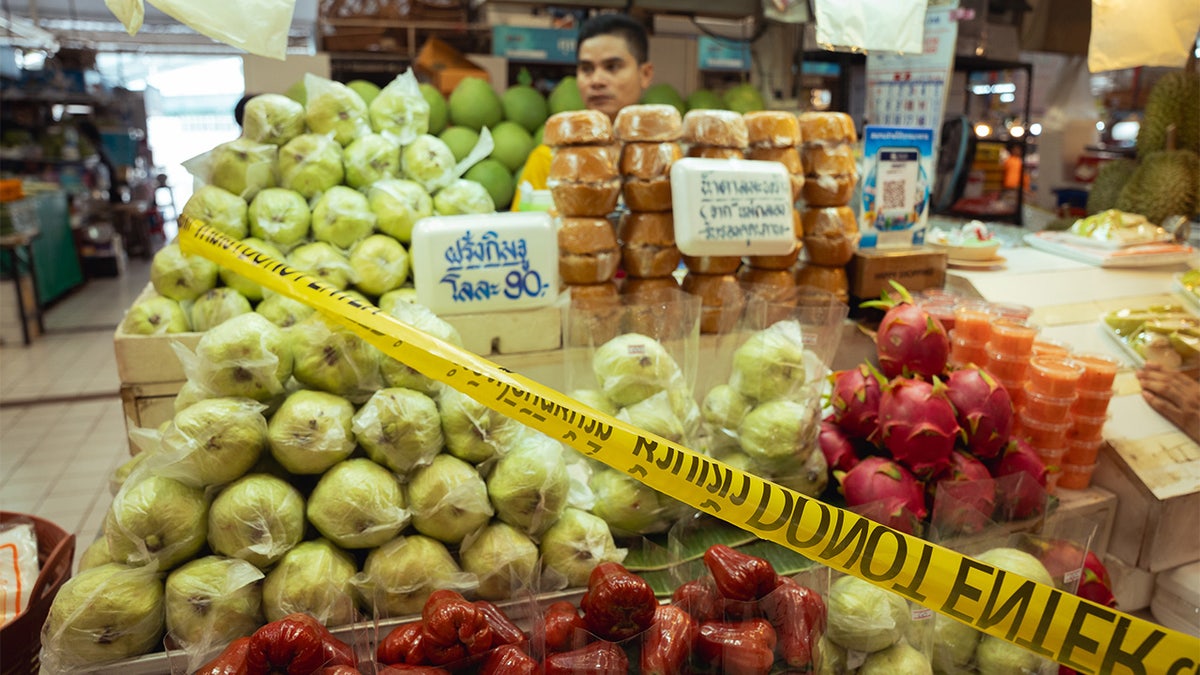 yellow crime scene tape at a bangkok market