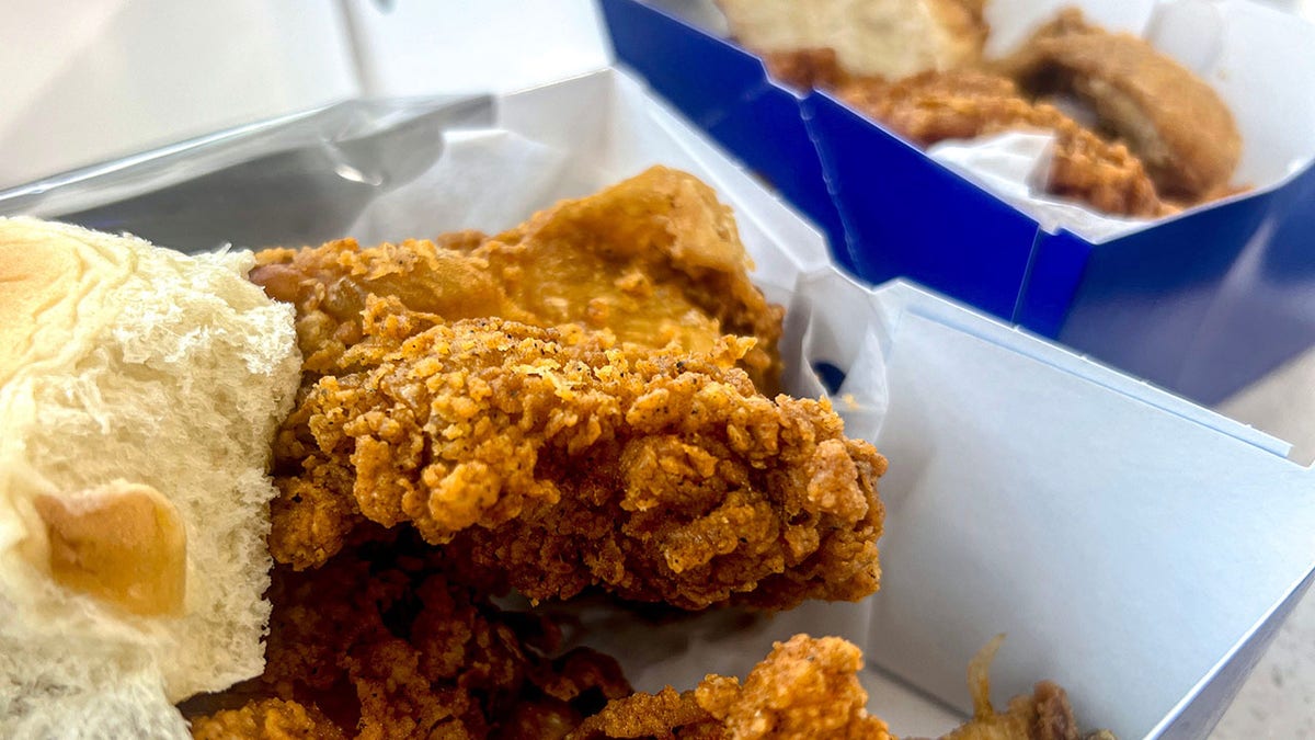 A fried chicken box with bread roll at Spinx stations.