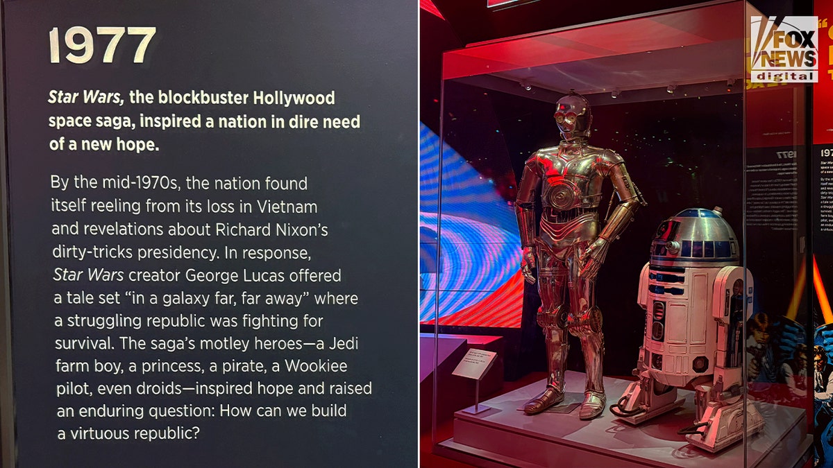C-3PO and R2-D2 at Smithsonian exhibit with panel praising Star Wars