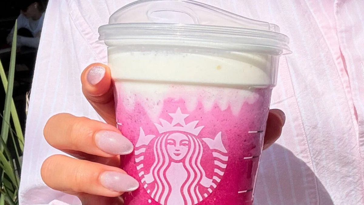Hand holding "Dragonfruit Glow-Up" drink from Starbucks