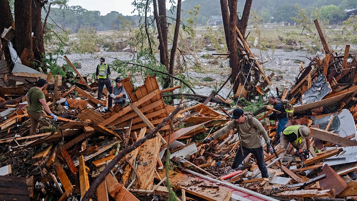People searching through Texas flood debris