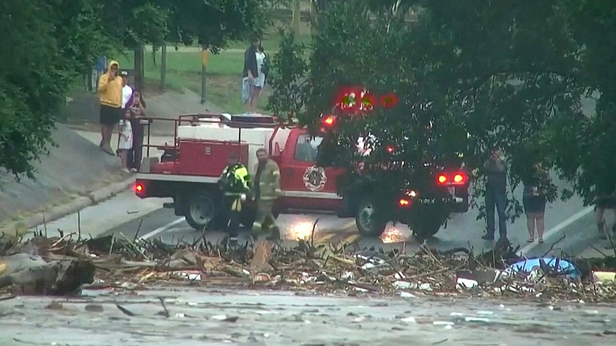 First responders survey rising flood waters of the Guadalupe River after flash flooding in Kerr County
