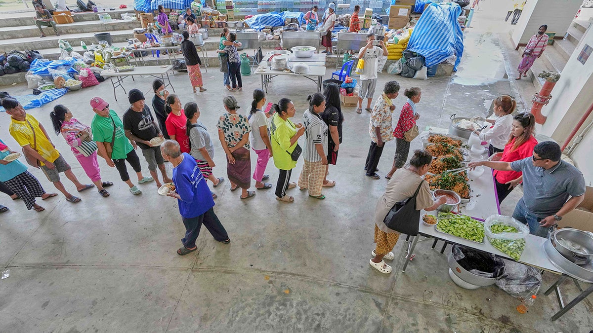 Thai residents line up for food