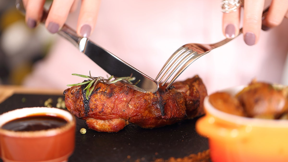 Close-up of steak being cut at restaurant