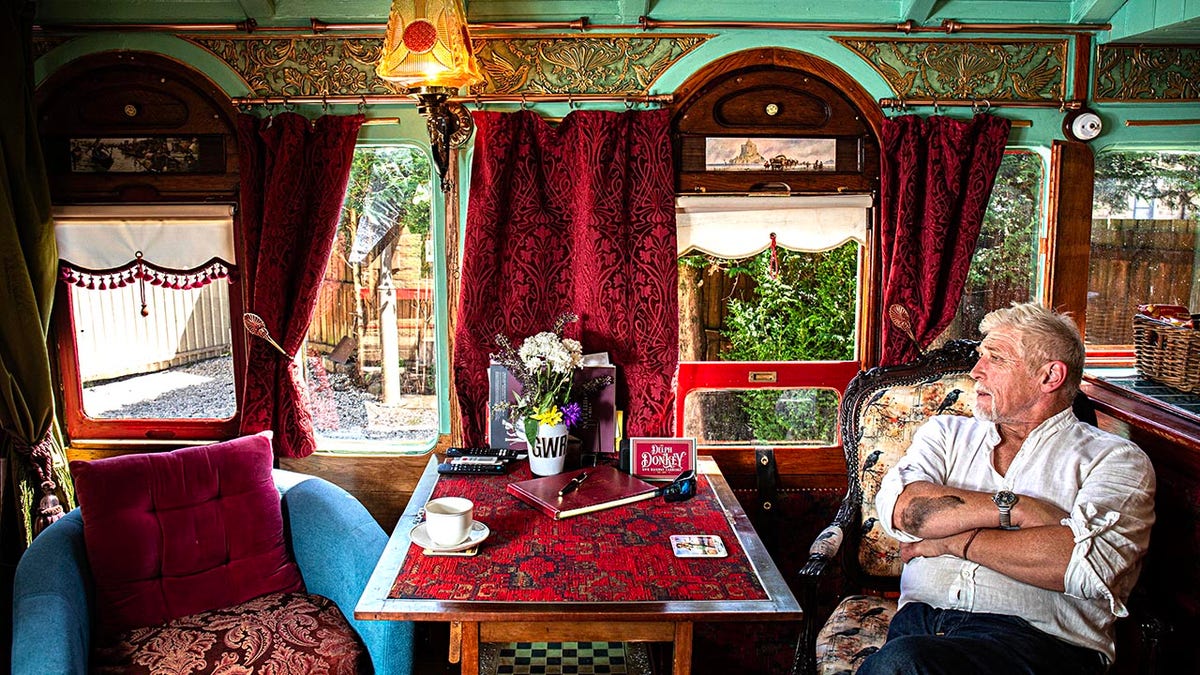 Nigel Brooke who lives in old railway station in Delph, Saddleworth, has refurbised an old classic train carriage in his garden and turned it into an Airbnb. See SWNS copy. 11/07/25