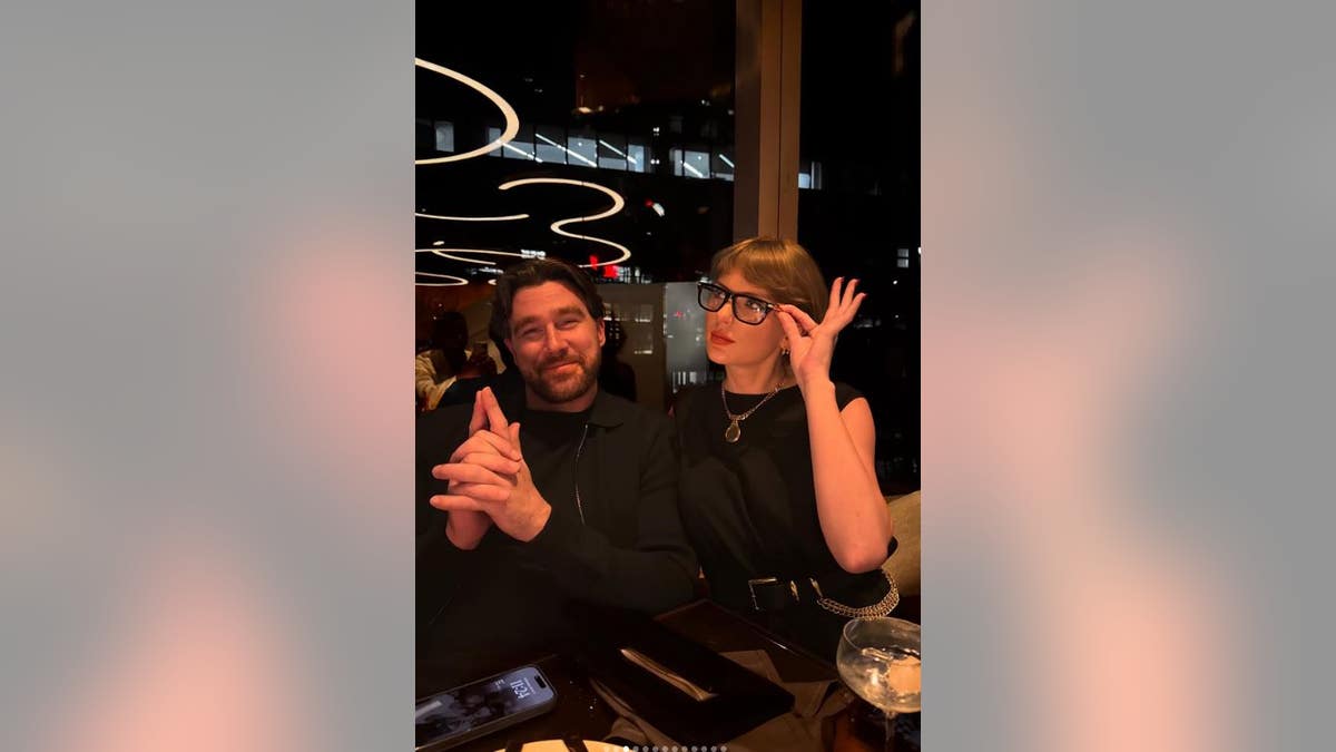Travis Kelce and Taylor Swift in a restaurant