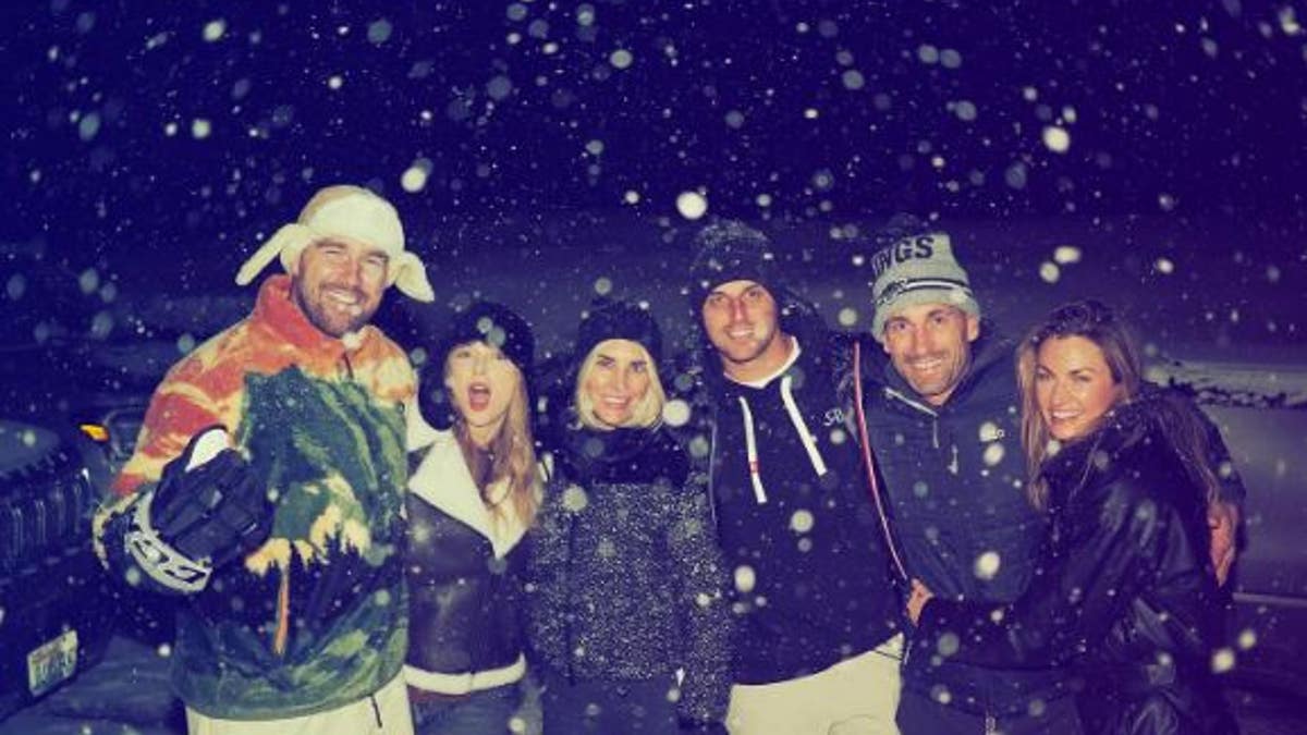 Travis Kelce and Taylor Swift with friends, including Erin Andrews, in the snow