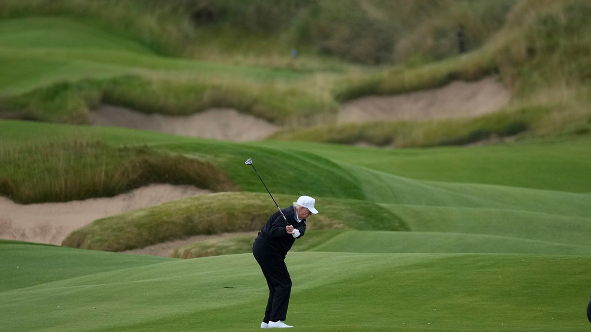 Trump plays at his golf course in Aberdeen, Scotland